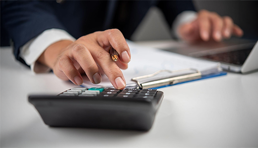 a gentleman, doing calculations on a calculator